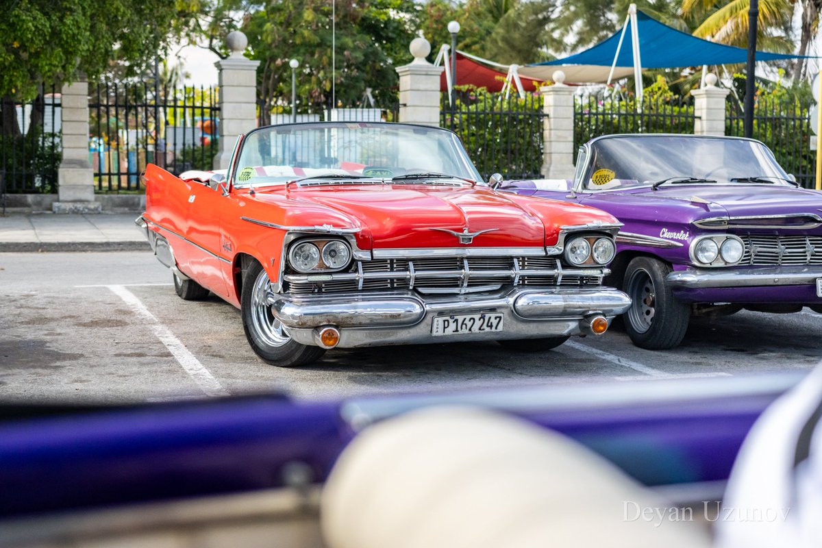 Vintage Vibes Near Malecon in Havana Transport yourself to a bygone era with this snapshot of nostalgia from the streets of Havana! Nestled near Malecon, this classic red retro cabriolet stands as a timeless symbol of Havana's enduring charm and vintage allure.