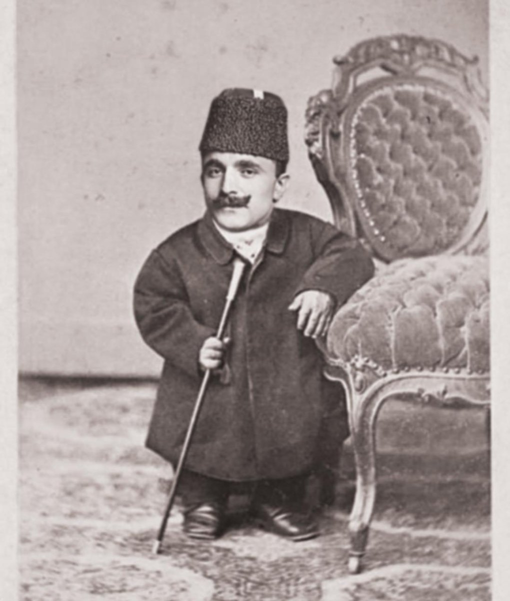 Unfortunately Enver Pasha had Sarcopenia.  
'Sarcopenia: Decrease in muscle mass, which leads to weakness and frailty and also a decrease in height.' 
 Last picture of Enver Pasha before Melkumov placed him under a marble.