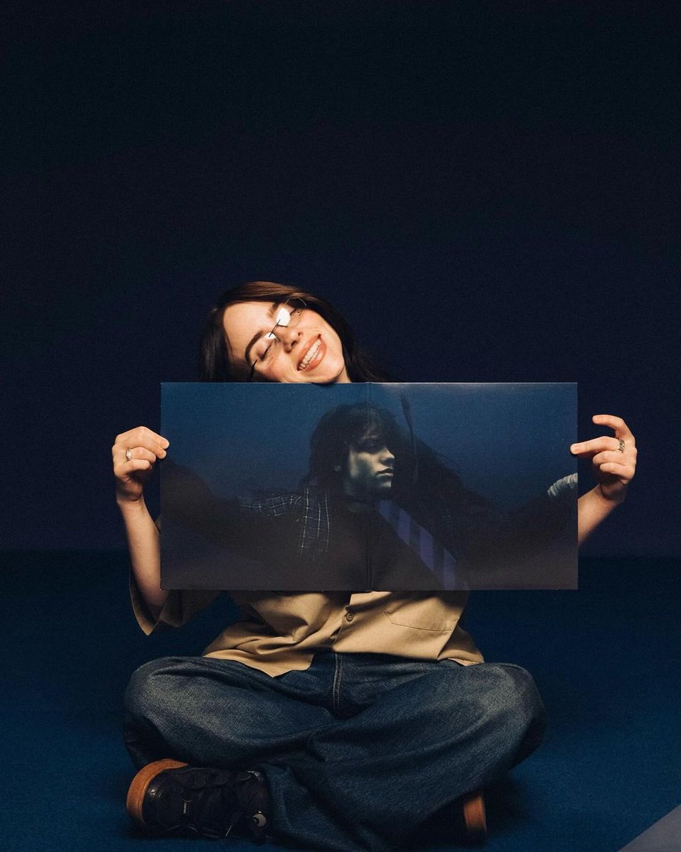 Billie posing with the 'HIT ME HARD AND SOFT' gatefold! 💙
