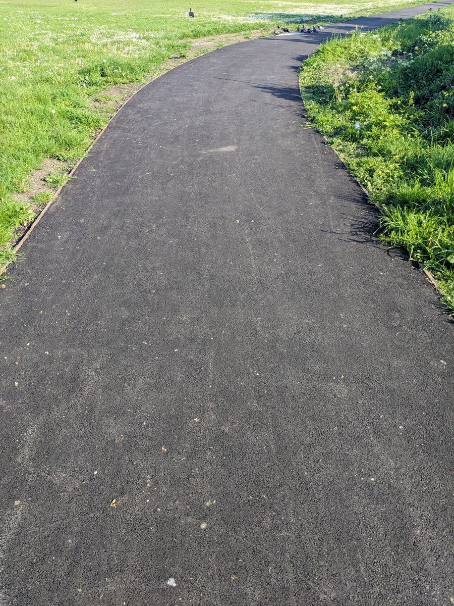 Black runway of tarmac scarring Three Kings Piece already going soft in the gentle heat of May - no sign of @Merton_Council's promised top dressing to reduce visual impact, allow pedestrians to hear cyclists behind them & keep it cool