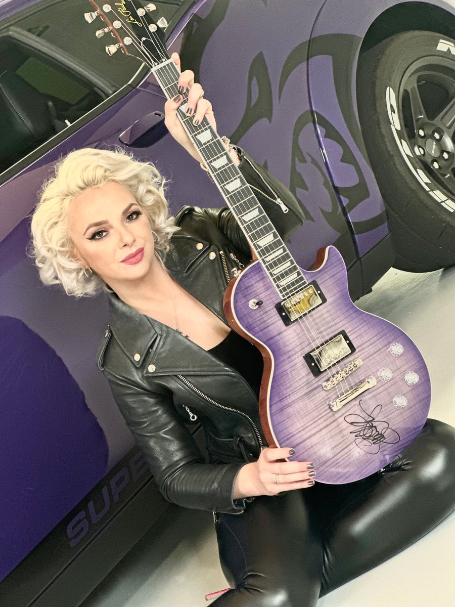 Blues artist @Samantha_Fish in the @DreamGiveaway Garage during the Challenger Dream Giveaway photo shoot. She's holding the Les Paul guitar she autographed for our future winner! See more at dreamgiveaway.com/dg/challenger #samanthafish #samanthafishmusic