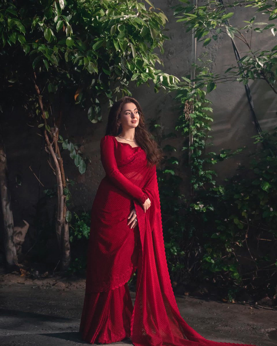 'Hania Amir embraces timeless beauty in a red saree.'