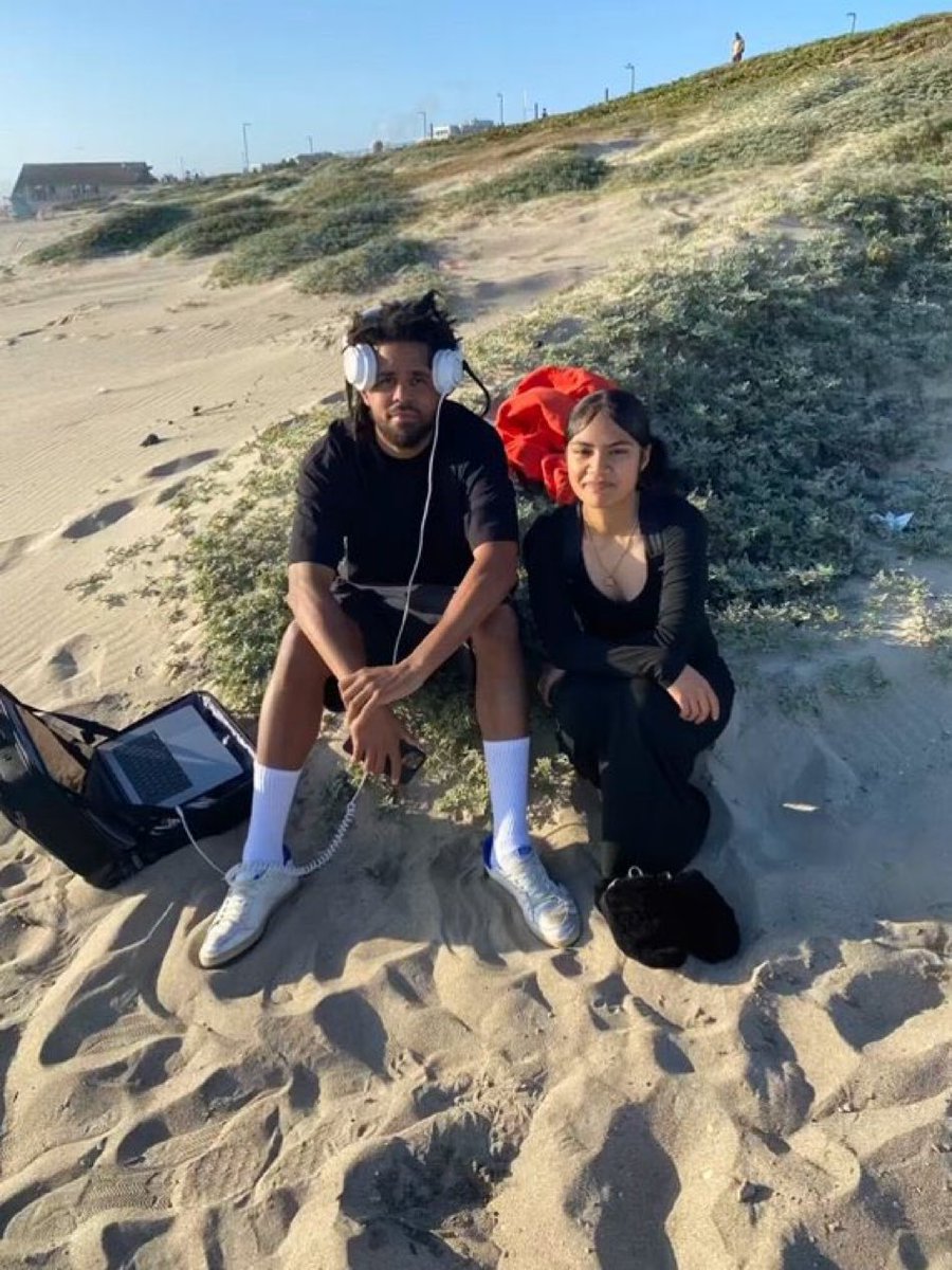 J. Cole with a fan at the beach 🏝️