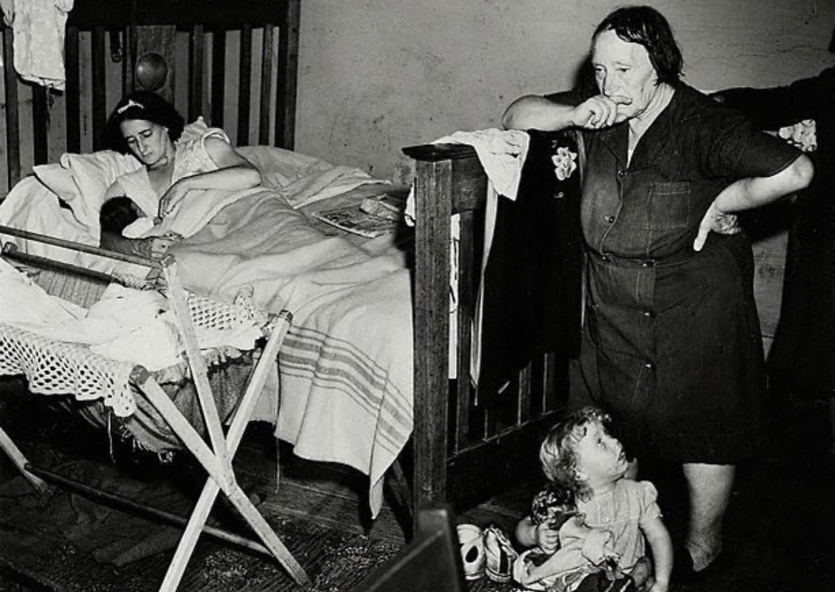 David Moore (1927-2003), Redfern Interior, 1947. ‘the cramped space, despair and poverty passing through three generations to a newborn baby, has little hope for change’ #art #photography #PhotographyIsArt #redfern