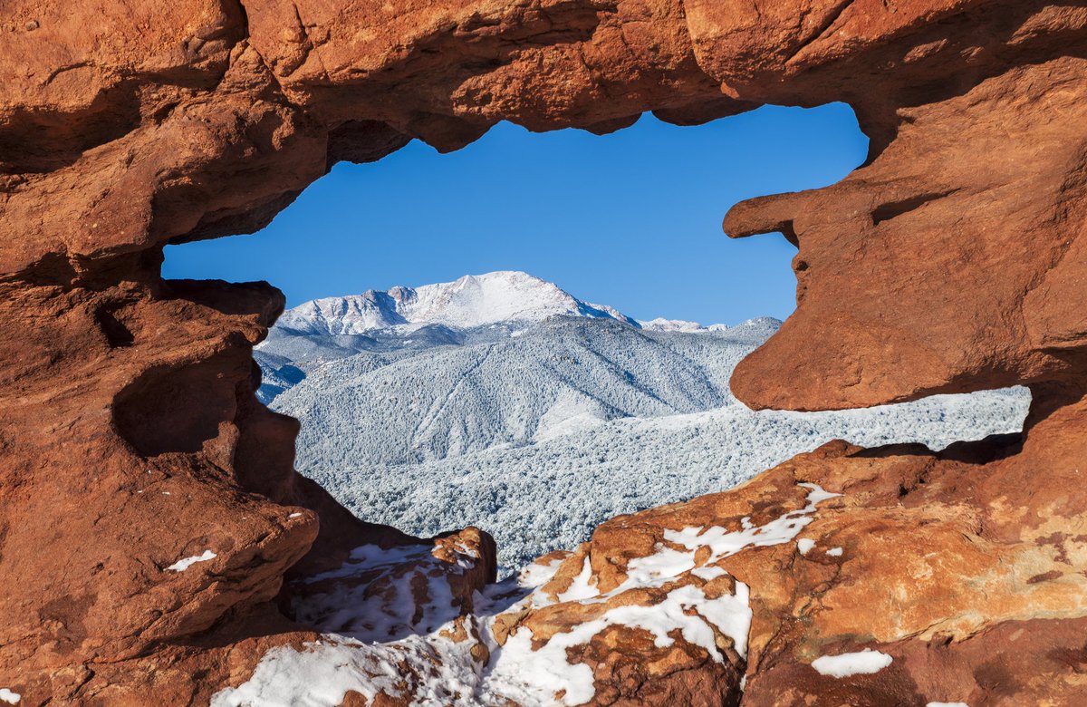 Pikes Peak framed with the Siamese Twins rock formation at Garden of the Gods. #Colorado #cowx #snowhour #photography