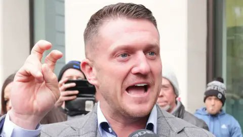 Stephen Christopher Yaxley-Lennon — alias Tommy Robinson.

Economic migrant, and political refugee, who lives in…

Spain. 

His supporters would reflect on this a moment.

If they were capable of rational thought.