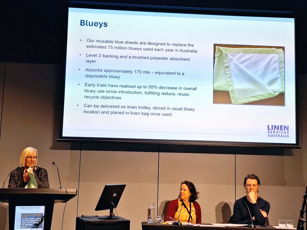 Donna Freer notes 75 million 'bluey' absorbent sheets are used in Australia every year.  Trials of reusable 'bluey' (which she has brought to the podium and is green 💚) show they perform just as well *and* decrease usage by 50% 🤯 #sustainability #RACS24