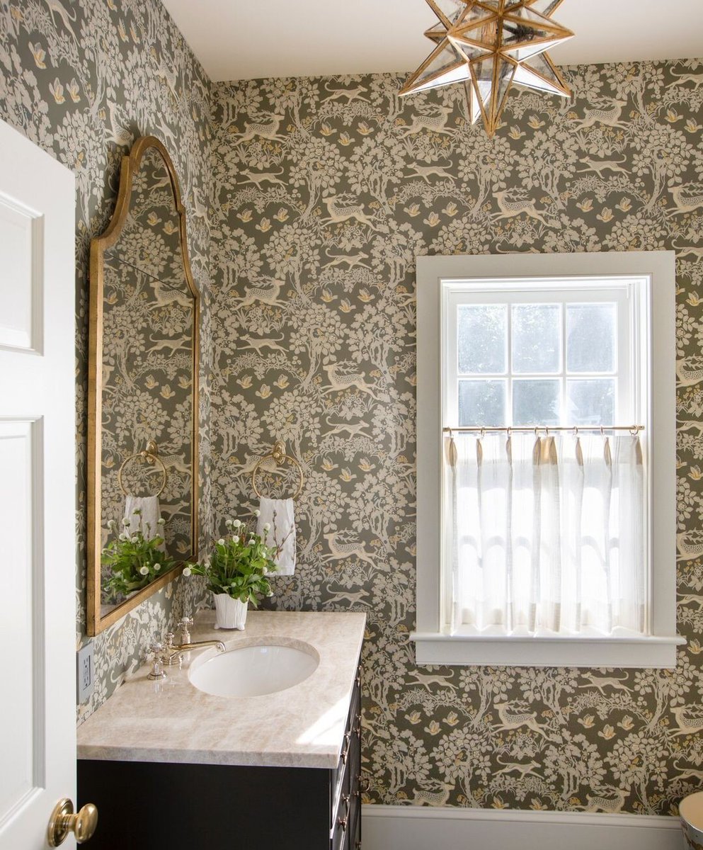 With its delicate floral motif dancing across the walls, Mille Fleur wallcovering sets a whimsical stage inside this powder room. Designer: @deborahleamann Photographer: @tomgrimesphotography
