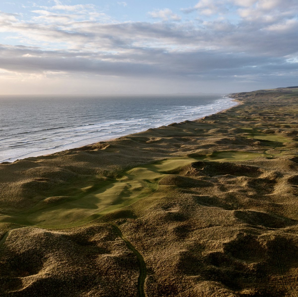 “It is all there in this rough-and-tumble stretch of picturesque duneland: elevated tees with breathtaking views across high shaggy sandhills; half-glimpsed fairways pitching and tossing at every imaginable cant or dog-legging gently around sentinel dunes; now a blind green in a…