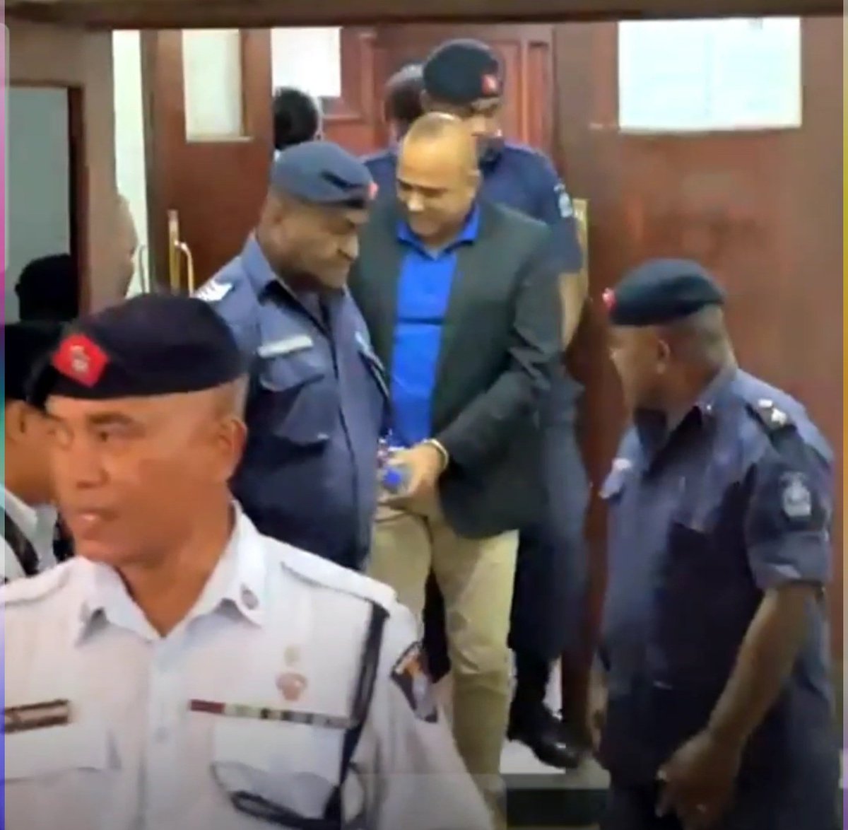 Former PM Frank Bainimarama emerges from court in handcuffs that has been coveted with a white piece of cloth. Former COMPOL Sitiveni Qilihio emerges from court in handcuffs.