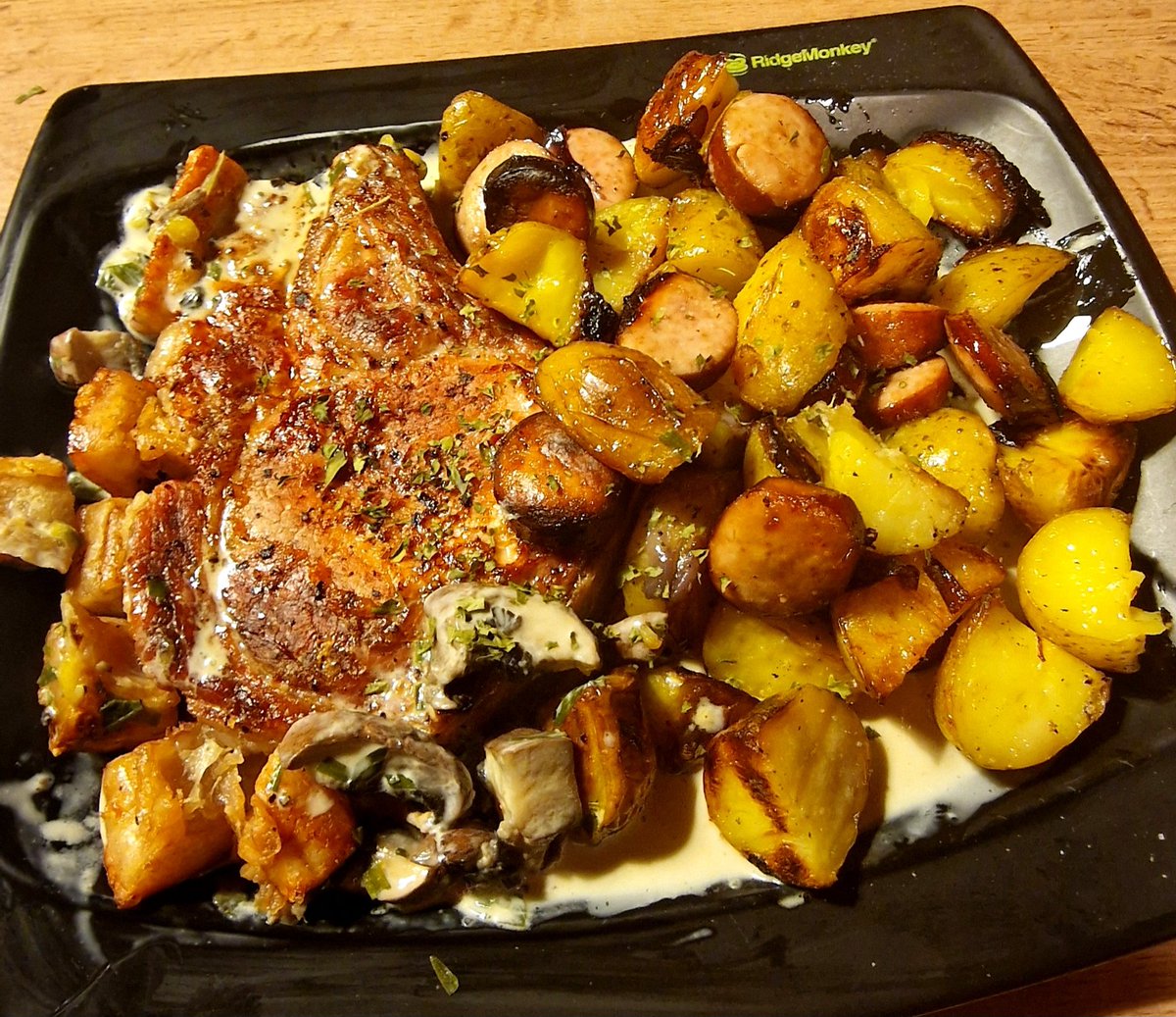 Tonights very late dinner. Free range Pork chop, garlic sausage, red onion, and potato bake, creamy mushroom and Tarragon sauce. 😎