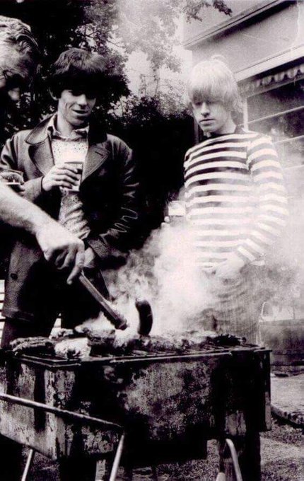 Keith Richards and Brian Jones of The Rolling Stones, at a BBQ, 1966.