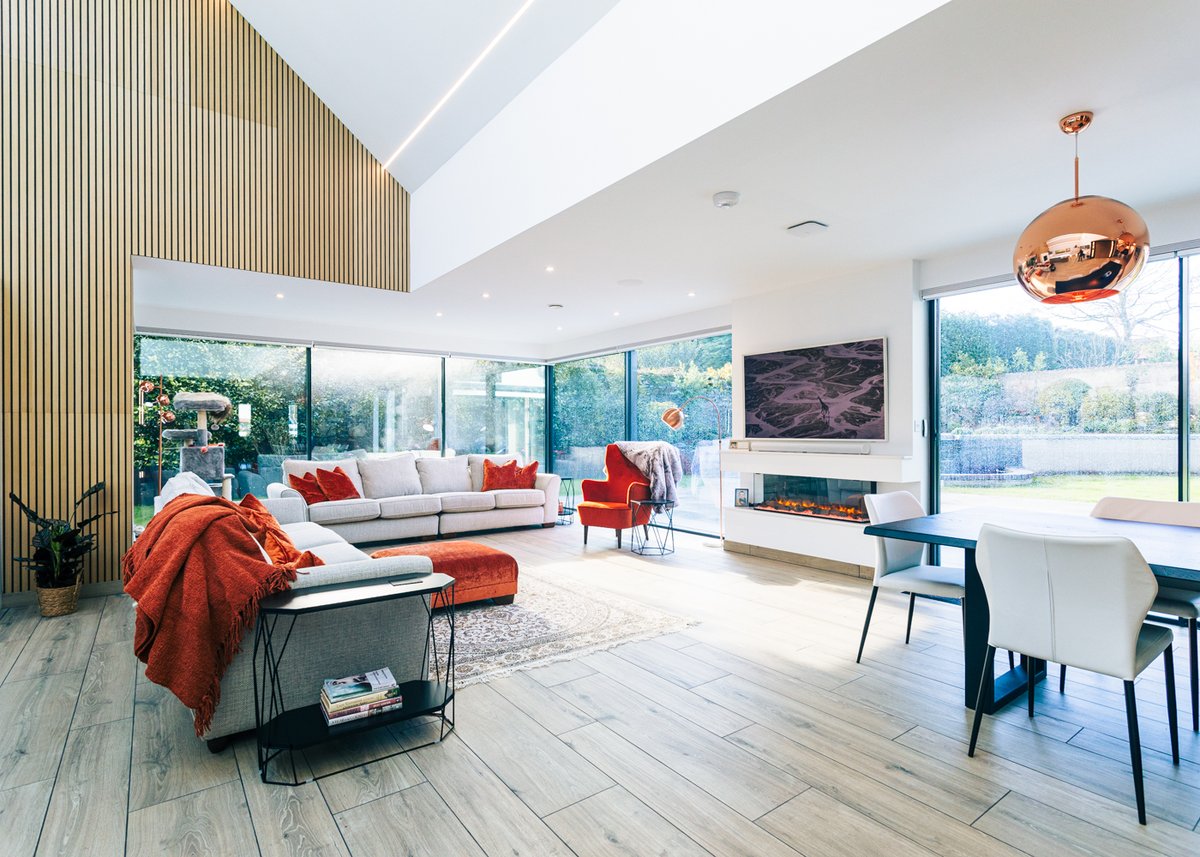 An all glass living room at Petit Maison on Guernsey. This modern house design uses architectural glazing from IQ to connect to the outdoors and bring in light from all angles. Read the full case study on the IQ Glass International website