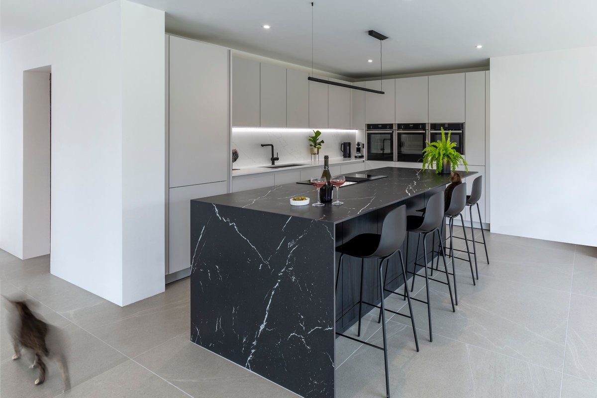 Combining a white kitchen with a black island creates a stunning and modern aesthetic. The contrast between the light and dark colors adds visual interest and depth to the space.