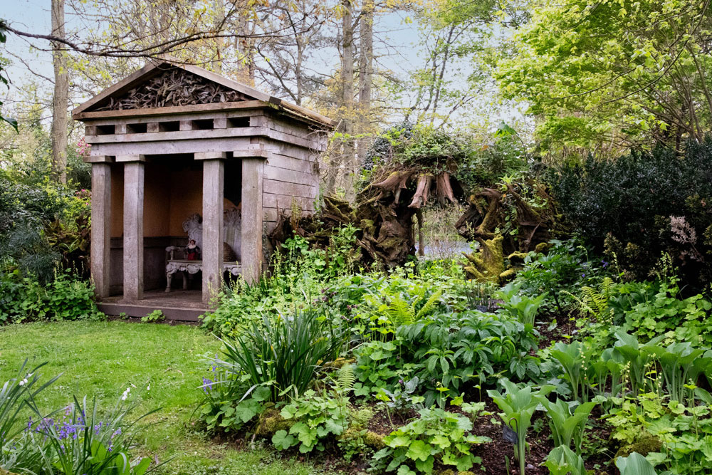 The Stumpery is transformed in May by a burst of rich green leaves and flowers, softening the angular architectural lines. It is a true masterpiece of nature and design, with its sweet chestnut stumps framing the elegant temples at its heart. 🍃🌿🌱