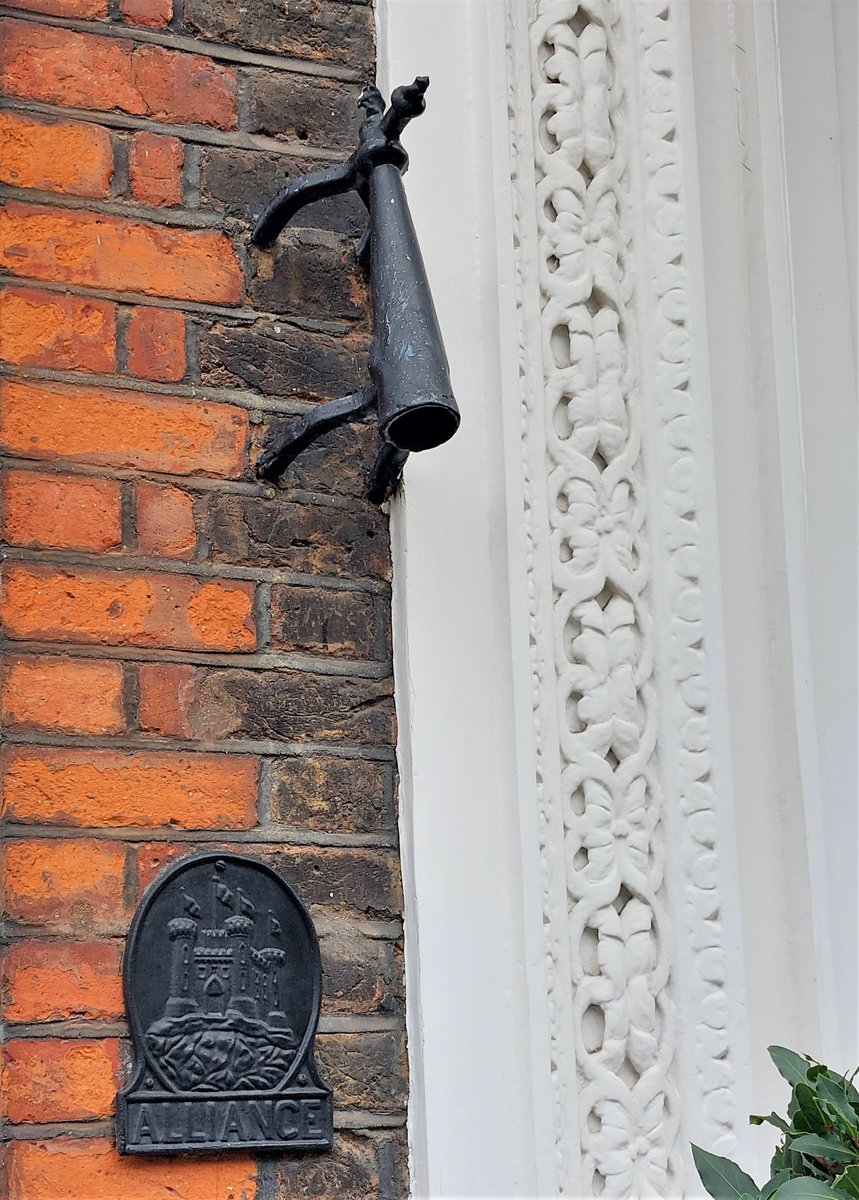 Double dip #IronworkThursday: torch snuffer and insurance plaque in Queen Anne's Gate, Westminster.