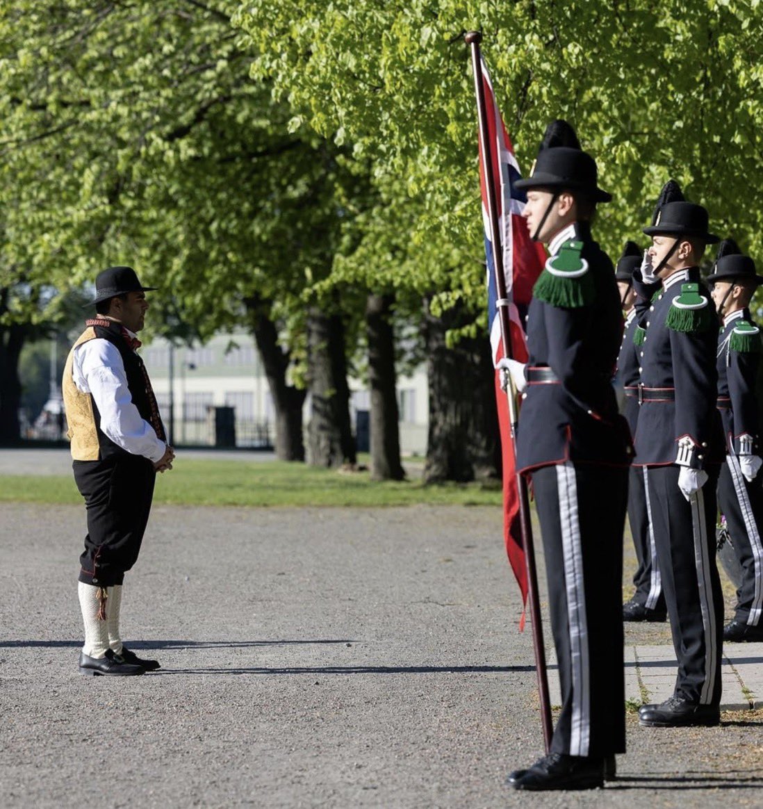 The diversity-hired-President of the Norwegian Parliament standing in front of Norwegian guards. A picture is worth a thousand words.