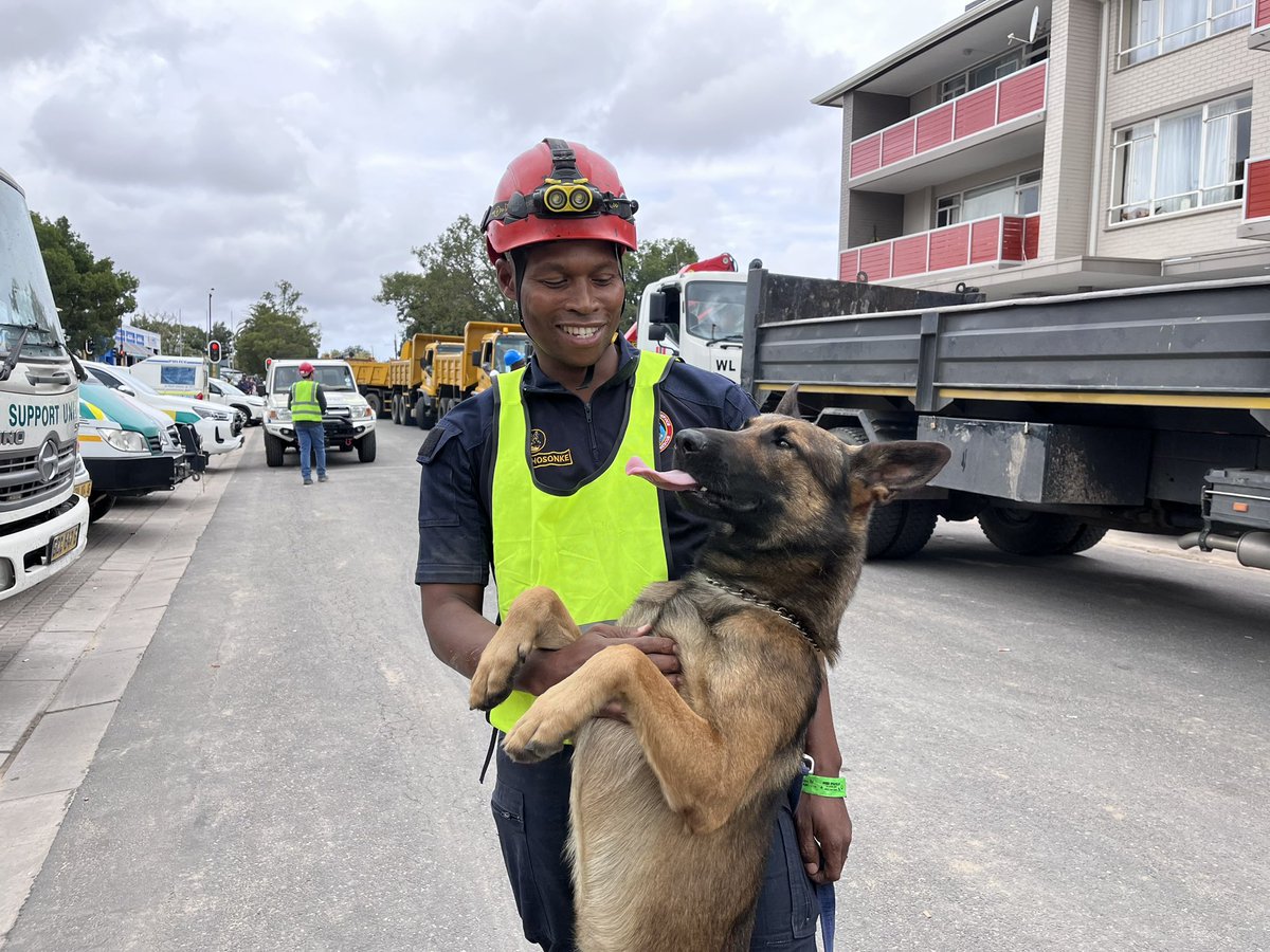 K-9 unit has played an important role in the rescue operation following the #GeorgeBuildingCollapse . Sergeant Buyisile Makhosonke from Lusikisiki in the Eastern Cape is pictured here with his dog, Bond. James Bond