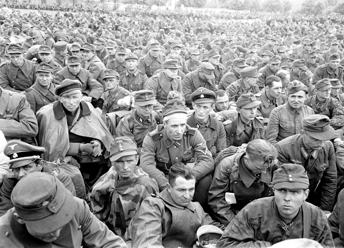 German Personnel in an Allied POW holding area near Tangermünde Germany - May 8, 1945
The man in the center with the head bandage has collar insignia for the infamous Dirlewanger Brigade.
LIFE Magazine Archives - William Vandivert Photographer