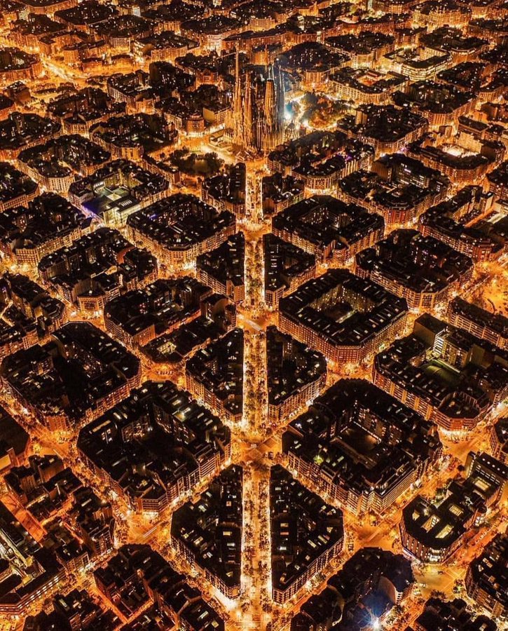 Barcelona by night. It's one of the world's most unique cities. The Eixample district is an unmistakable grid of some 900 seemingly similar city blocks master planned by Ildefons Cerda. And it looks like a honeycomb from above because of its many small, tightly packed blocks,…