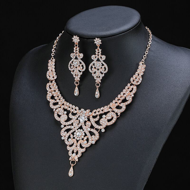 Discover the ultimate in sophistication with a Vintage Rose Gold Rhinestones Necklace and Earrings Set from YongxiJewelry.com. This stunning necklace and earring set, featuring clear gemstones, will make you shine on any occasion. 
 #LuxuryJewelry #YongxiJewelry #GiftForHer
