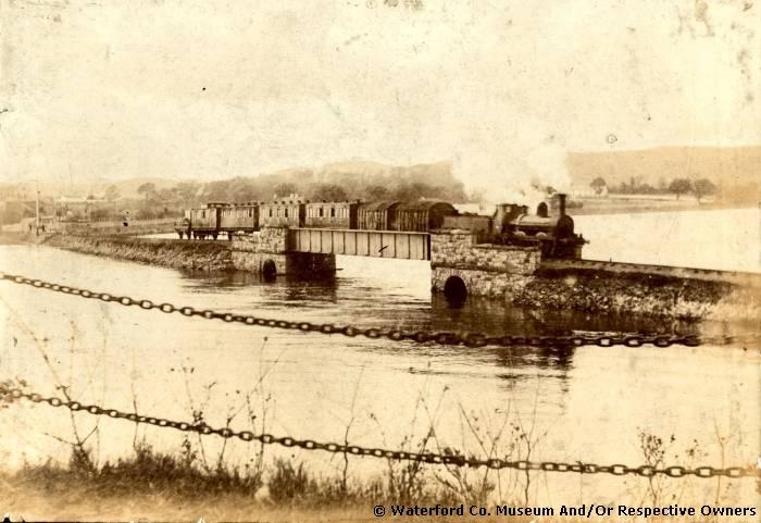 The railway bridge adjacent to the Causeway, Abbeyside, Dungarvan, Co. Waterford. Then c1920 and now.