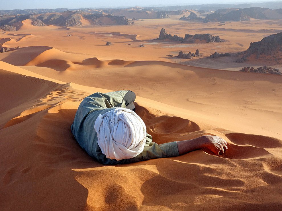 Nap time. A Tuareg guide rests at the summit of Tin-Merzouga, the largest dune (or erg) in the Tadrart region of the Sahara desert in southern Algeria. 

📷: Evan Cole | National Geographic