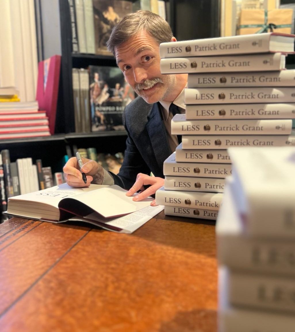 Signing copies of my book LESS which is out day.