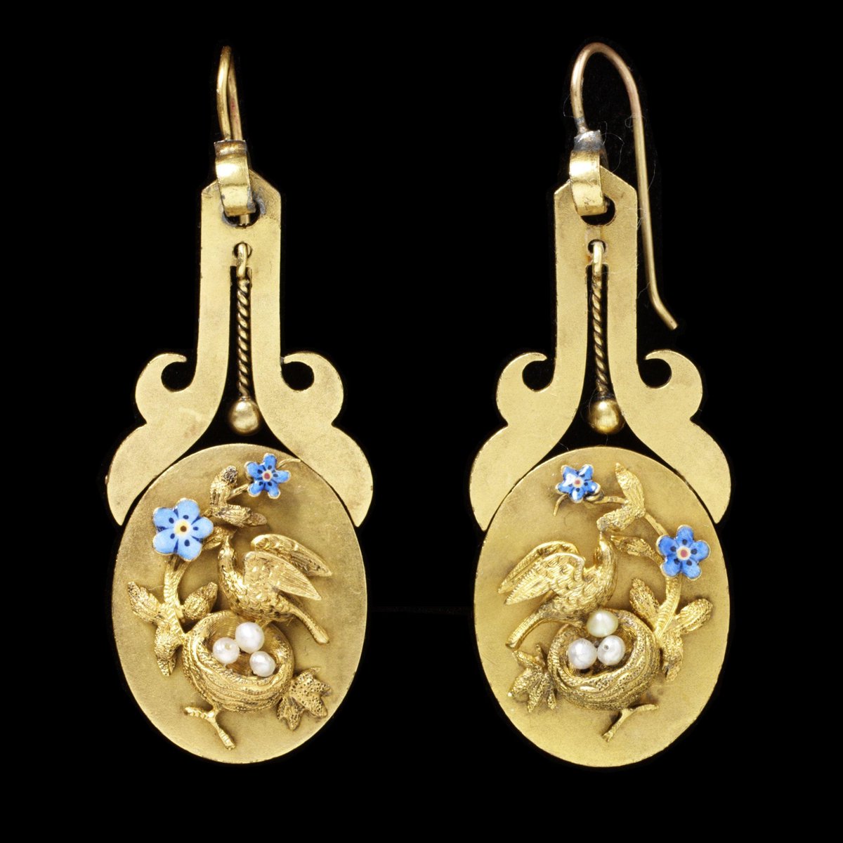 Pair of earrings, gold plaques decorated with compositions of a bird, a nest with eggs, and forget-me-nots, London, England, about 1860-70. Victoria & Albert Museum.
