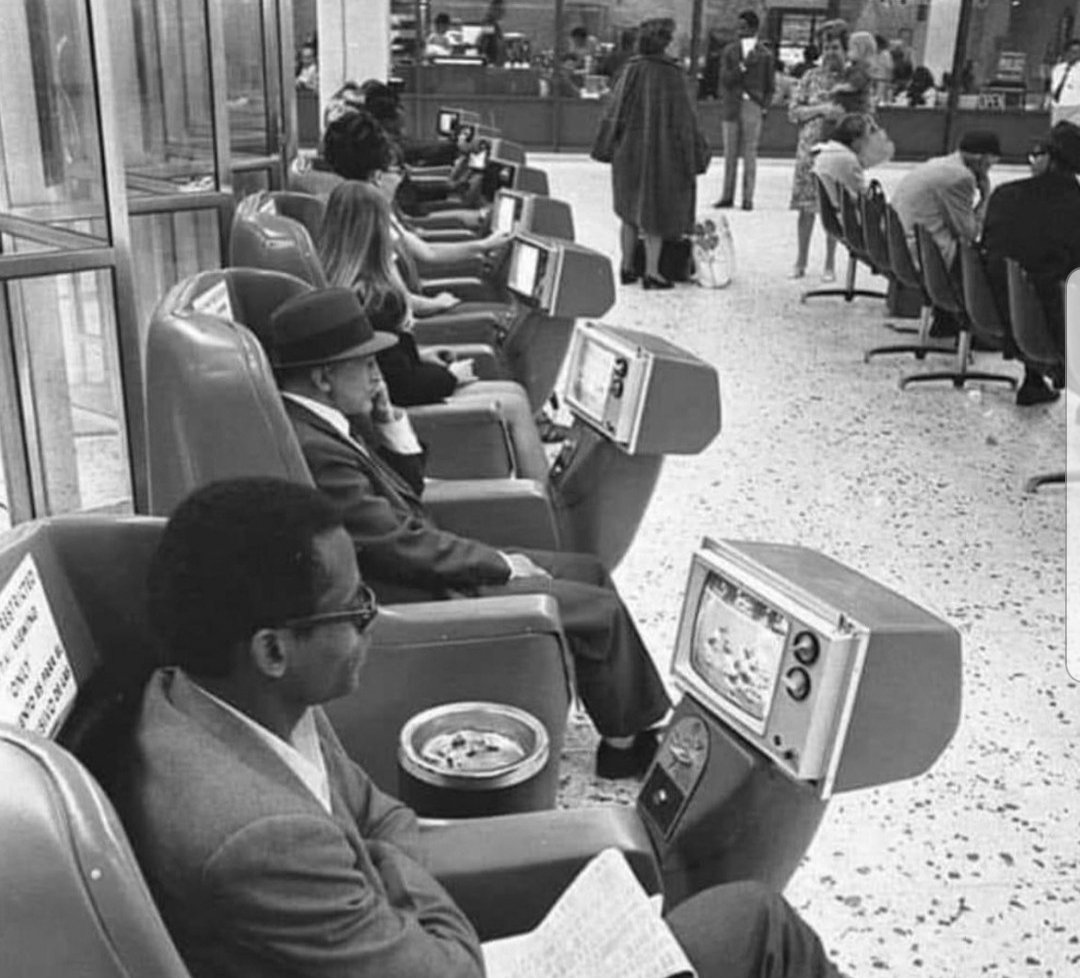 Passengers watching coin-operated Tv's in the L.A. Greyhound bus station