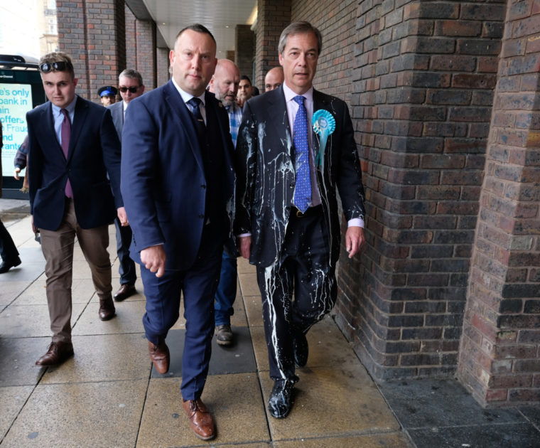 What is going on ? Nigel Farage being led to safety after being held hostage in a flat by 6 very naughty men