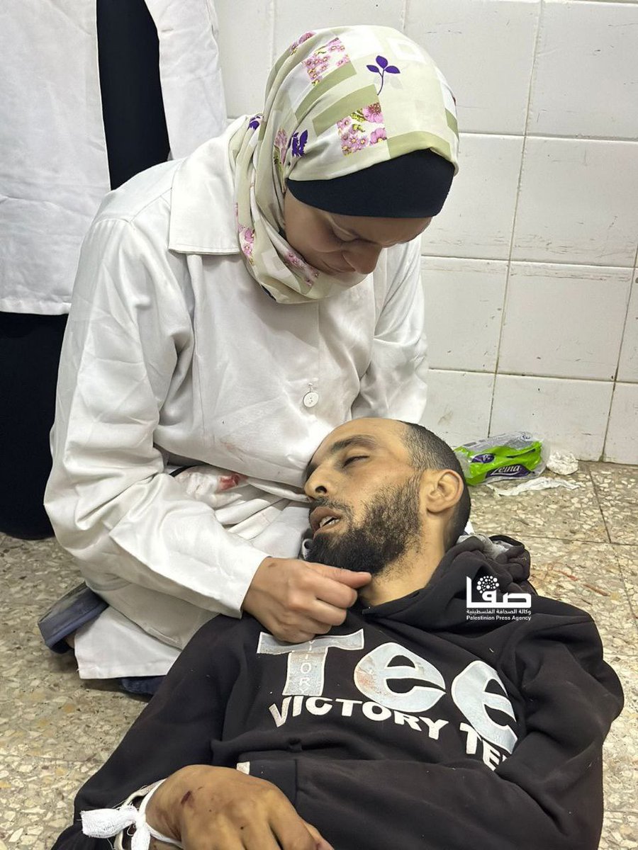 A nurse is shocked to find her brother's body among civilians hit by Israeli warplanes on Salah al-Din Street near the northern entrance of Al-Bureij refugee camp in central Gaza.