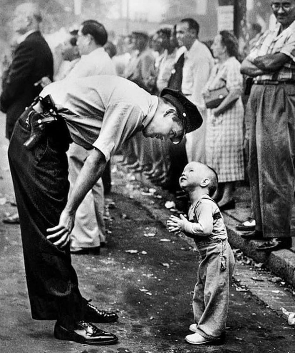William C Beall, of the Washington Daily News, won a Pulitzer Prize in 1958 for this photograph of a policeman and a two-year-old boy trying to cross a street during a parade 1957. Photographed by William C Belle.