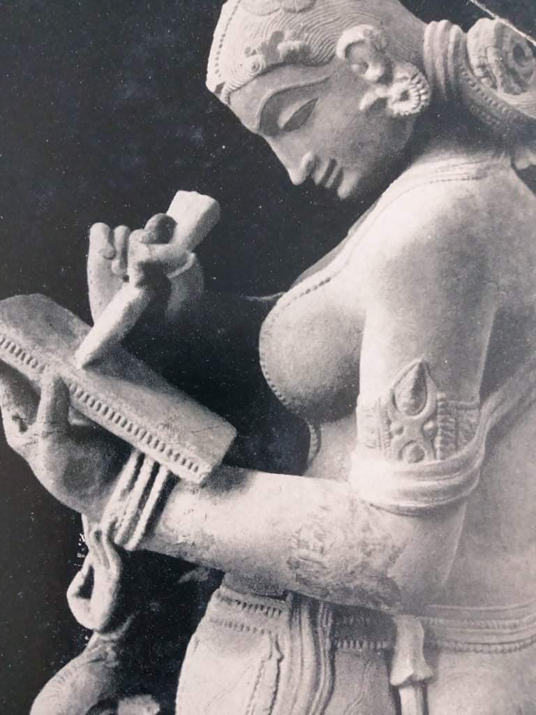 A 1,000 years old sculpture of a woman writing a letter, Chandel Period,  Khajuraho, Central India.