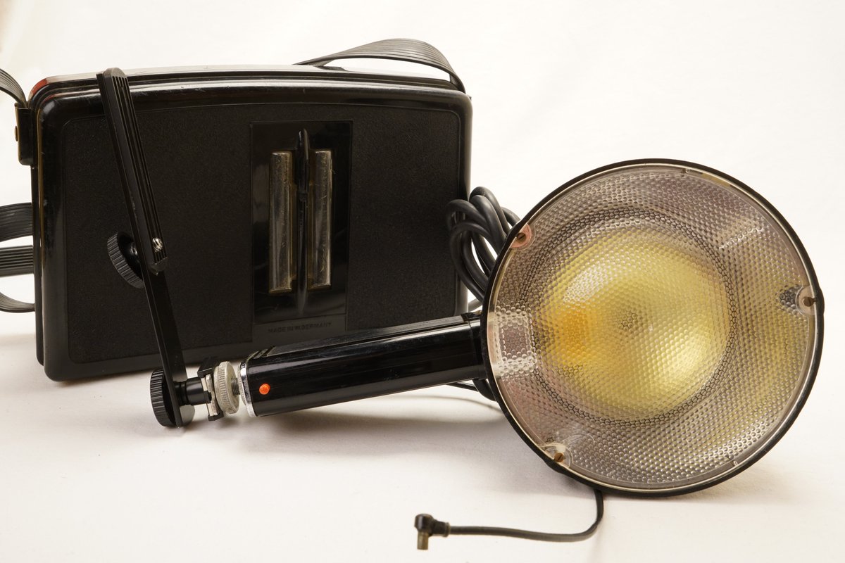 Mecablitz Proffesional Flashgun 1950's. Taking shots with a flash gun once had a heavy bit of kit to carry around. The rechargeable battery was in a bakelite case, with high pitch sound as the battery built up power before the indicator light turned green.