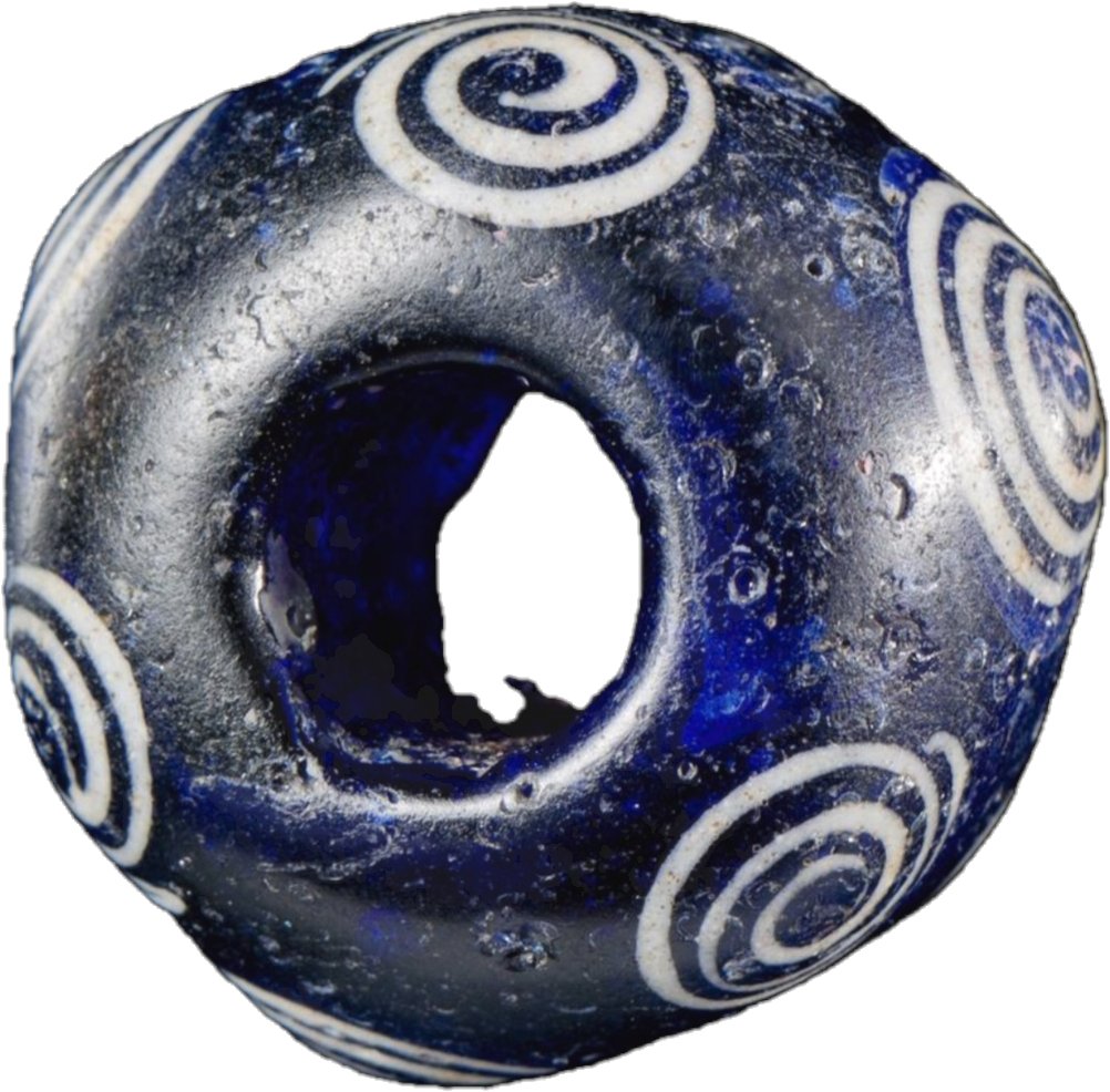 Late Iron Age bead of royal blue glass with nine white swirls three of which raised found at Glanbidno Uchaf, Llangurig, Powys. Image NMW. #findsfriday museum.wales/collections/on…