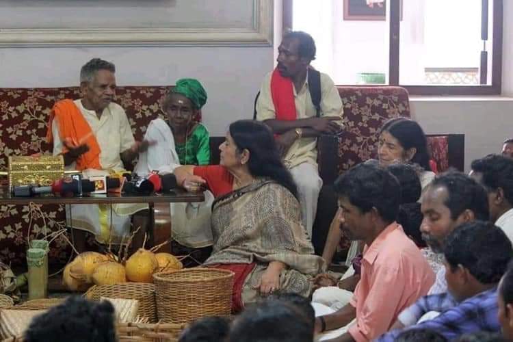 This is incorrect information. Tribal Chiefs come to their Palace during onam to gift their agricultural produce. Annual Ritual this is. The ladies sitting down are the Travancore Royals, Pooyam Thirunal Gowri Parvathi Bayi and Ashwathi Tirunal Gowri Lakshmi Bayi.