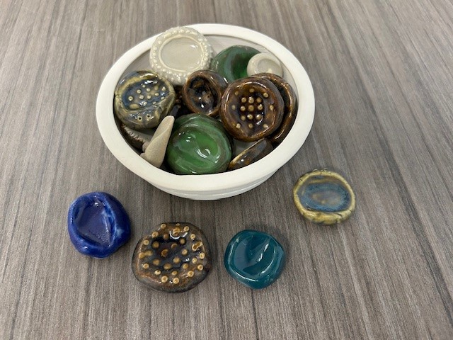 As we wrap up Mental Health Week we are thankful to our ceramics students for creating grounding stones for our Ravens.  You can de-stress anywhere with stones that fit perfectly in your palm.  Pick yours up in the main office.  Go Ravens!