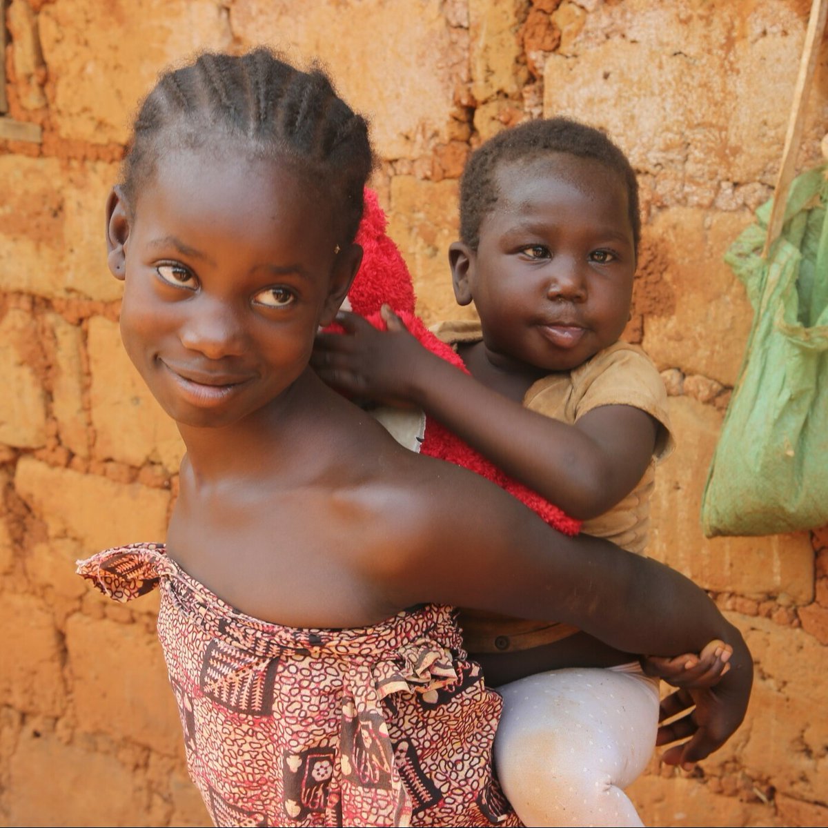 Sharon is a beautiful 5-year-old with cerebral palsy. She’s been working hard to gain strength with her parallel bars but can’t get around on her own quite yet. Thankfully, she has an older sister, Sandrine, who loves carrying Sharon to help her get around. #PhotoFriday