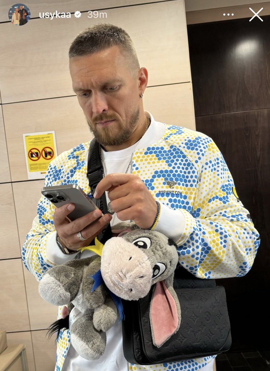 Oleksandr Usyk travelling to Saudi Arabia for the Tyson Fury fight today with the same cuddly toy of Eeyore that he had at the Anthony Joshua fight: 'It's my daughter's. She gave it to me to be my talisman and said, 'This needs to be right next to you.' It is always close to me.'