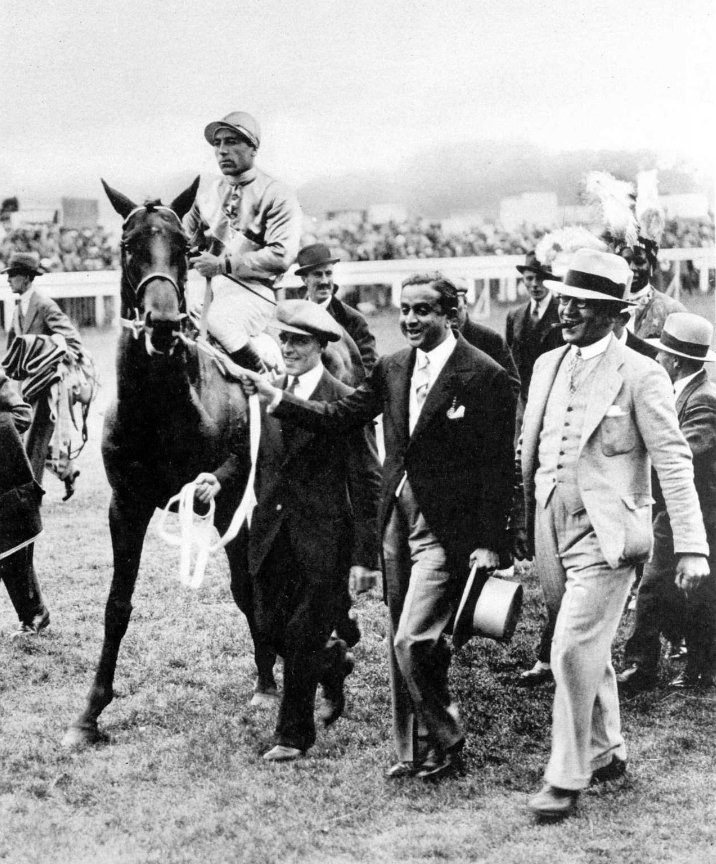 H.H. The Maharaja of Rajpipla, Shri Sir Vijaysinhji, Leading-in his Windsor Lad, the Winner of the 1934 Derby.

1 of 2