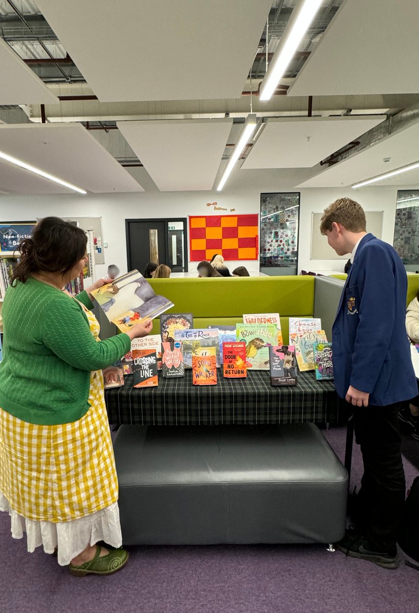 Miss Sarran and a literacy ambassador @InverurieAcad  looking through our display of the shortlist for this year's @CarnegieMedals.  Many thanks to @scholasticuk for this wonderful prize! We are looking forward to reading and discussing them! #YOTOCarnegies24