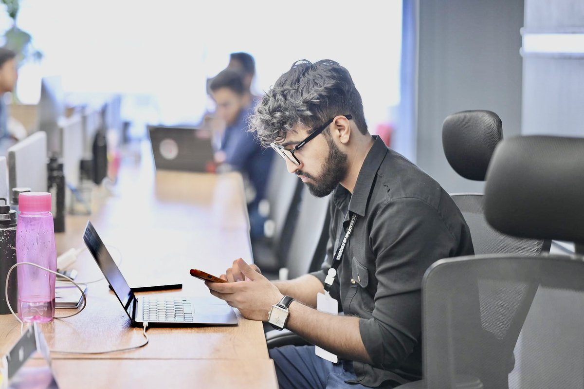 Talhaverse's tweet photo. Just me, multitasking at its finest: pretending to be productive on my laptop while actually mastering the art of phone-scrolling. 💻📱 #ProcrastinationGameStrong https://t.co/dQ66CUVhsK