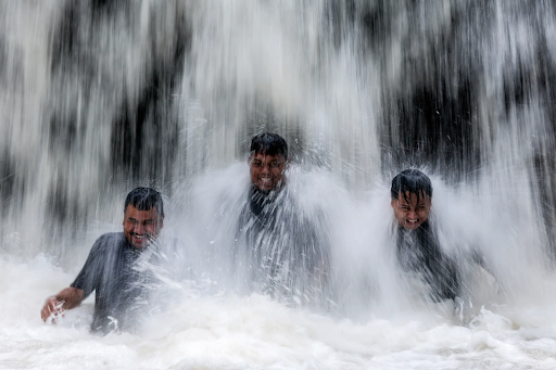 #SundayStill 📸 SUMMER COMES EARLY As a record-setting, deadly heatwave scorched Southeast Asia, Malaysian EPA photographer Fazry Ismael caught the rapture of three men cooling off under a waterfall outside of Kuala Lampur on April 30.