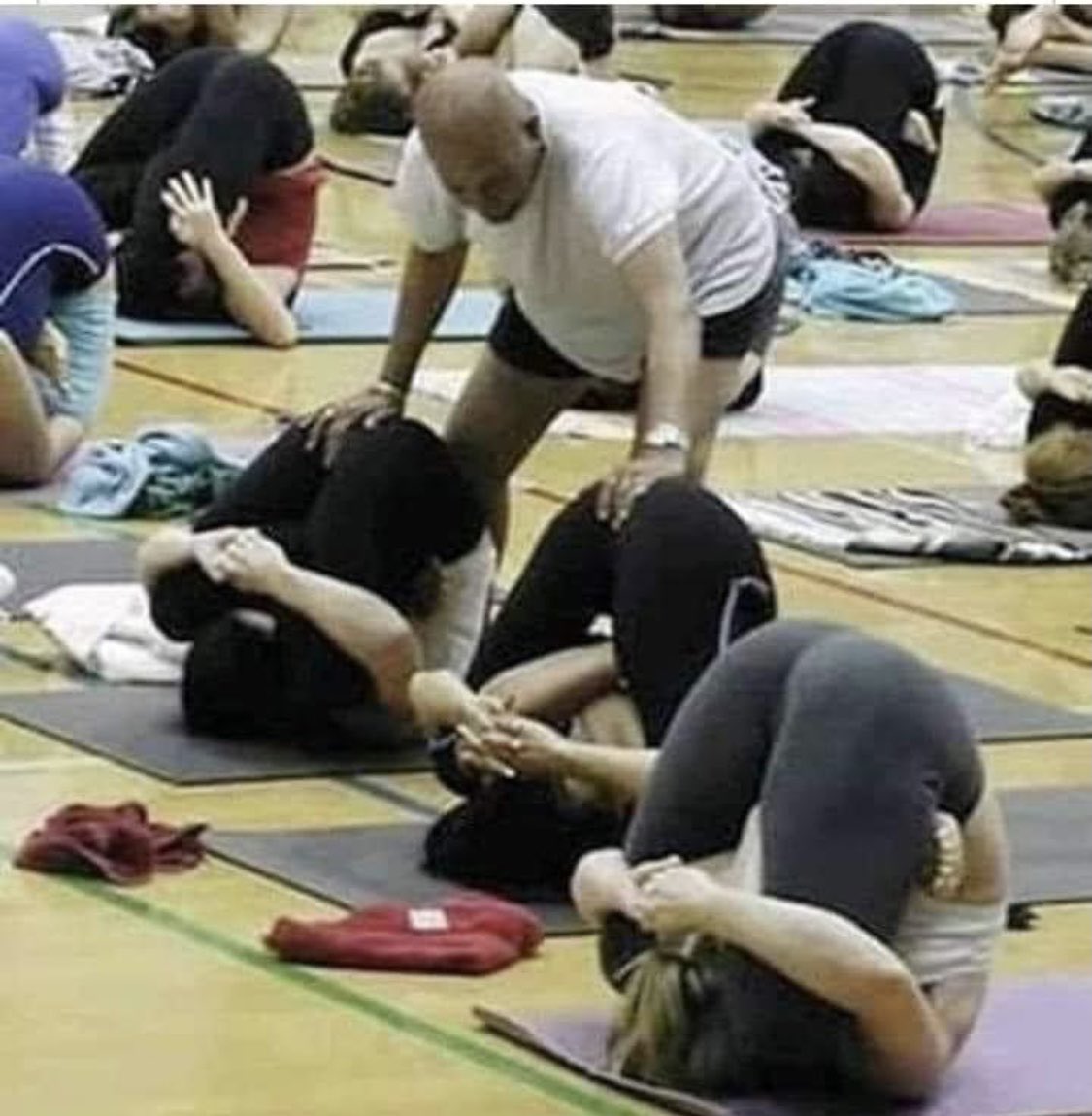 Ladies... raise your hand if you would go to a yoga class with a fat, bald, male instructor. Much less one that had you doing these poses. What a pervert! These women are most likely liberals with no brain cells and sees absolutely nothing wrong with this. PERV!