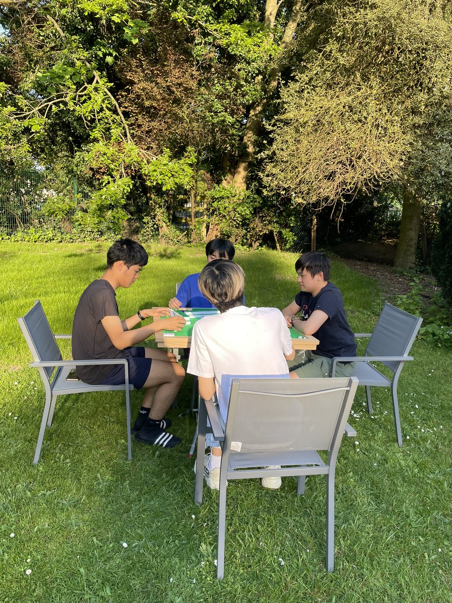 Summer has definitely arrived. Mahjong in the evening sun in the School House garden.