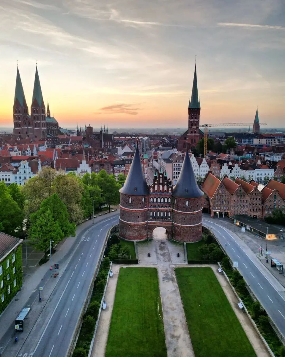 Lübeck, Germany 🇩🇪

The Holstentor, a UNESCO World Heritage Site, is a medieval city gate that dates back to the 15th century. It is an impressive example of Brick Gothic architecture, characterized by its red brick construction, pointed arches, and decorative elements.