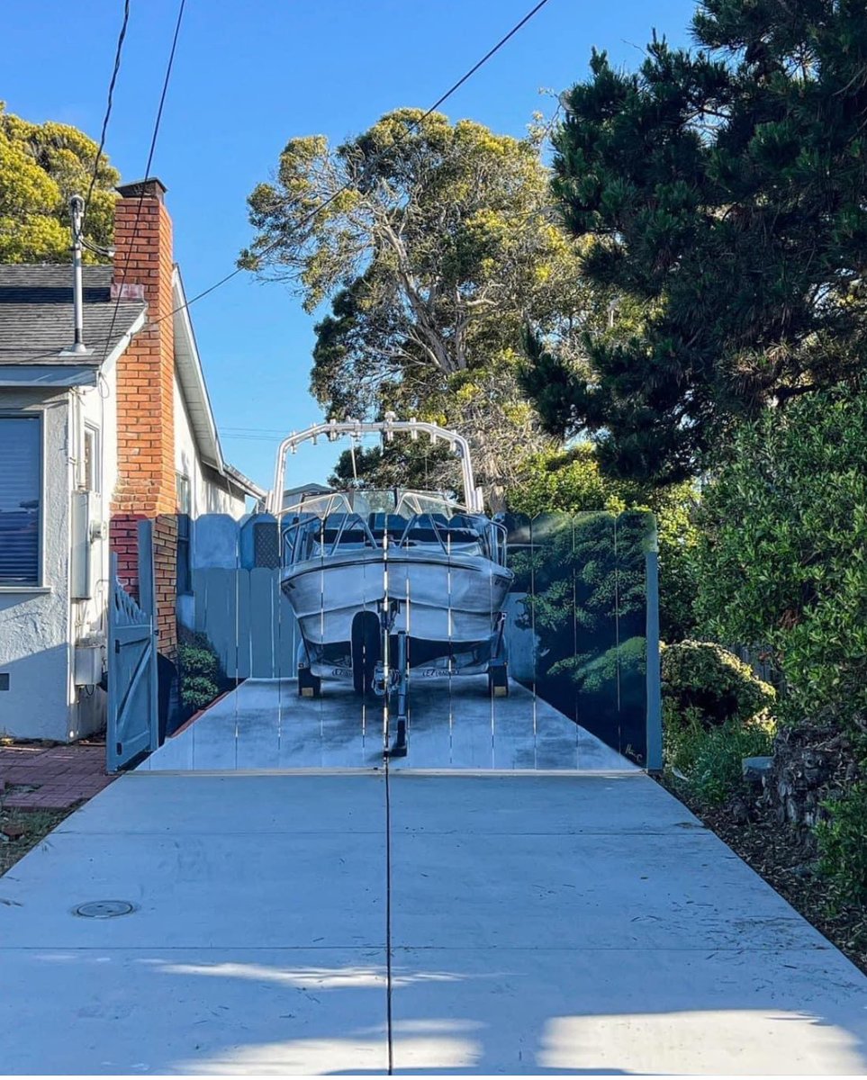 Man who kept his boat besides his house was ordered from the city to put up a fence to hide the boat from view. So he built the fence and hired someone to paint it.