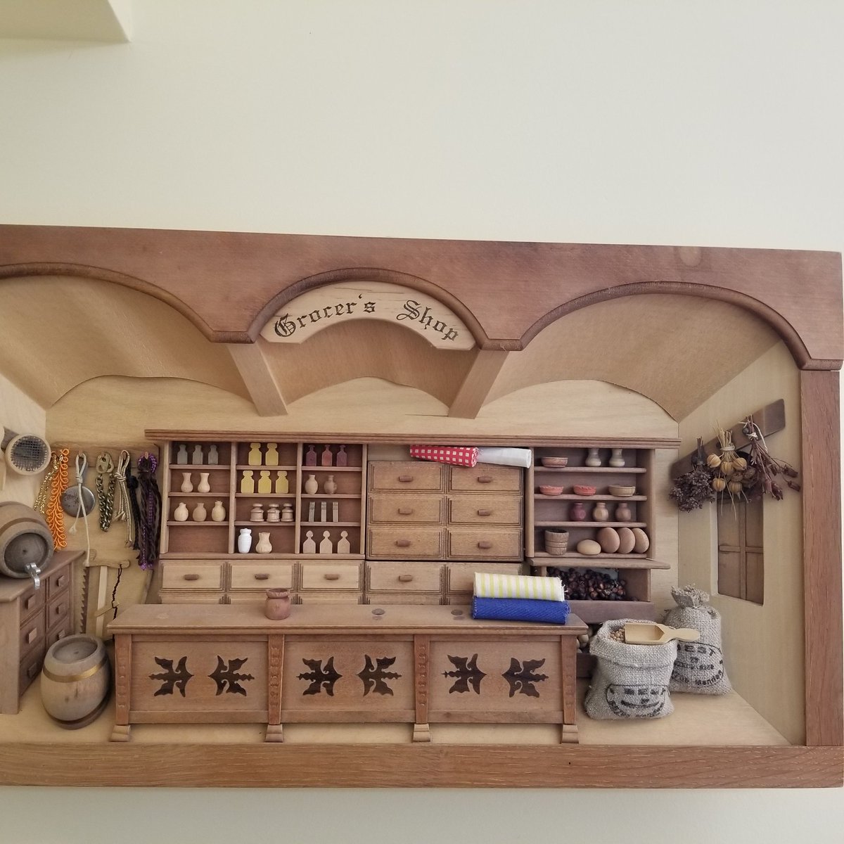 LMM_digital's tweet photo. Thx @mwxannex506 Your photo reminds me of my own little display - a miniature wooden Grocer's Shop,  ~20 by 12 inches. Purchased on north shore of PEI a few years ago. Reminds me of General Store where Matthew buys Anne the  puff-sleeved dress.
Love the bottles/jugs on shelves! https://t.co/guAtLZEmyj