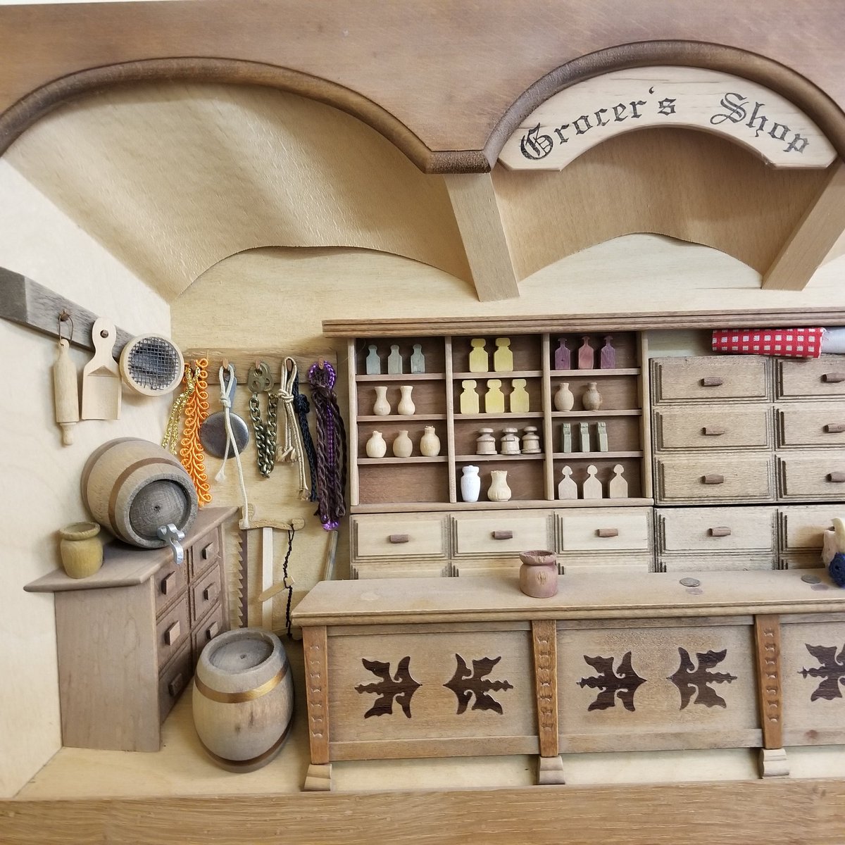 LMM_digital's tweet photo. Thx @mwxannex506 Your photo reminds me of my own little display - a miniature wooden Grocer's Shop,  ~20 by 12 inches. Purchased on north shore of PEI a few years ago. Reminds me of General Store where Matthew buys Anne the  puff-sleeved dress.
Love the bottles/jugs on shelves! https://t.co/guAtLZEmyj